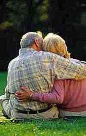 couple sitting on grass, embracing