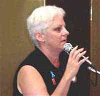 nikki meloski speaking at a microphone