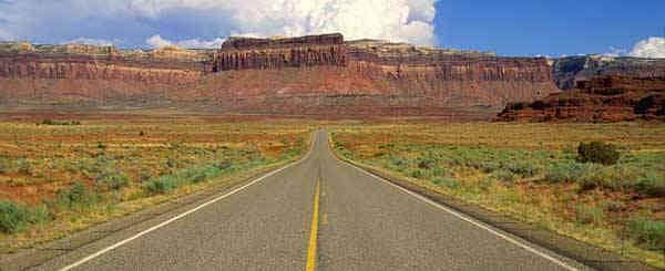 highway disappearing towards mountains