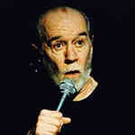photo of george carlin with a microphone
