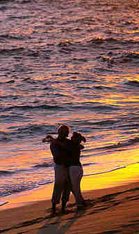 couple embracing on a beach at sunset