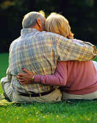 couple seated embraced on lawn