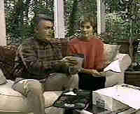 frame from video showing couple opening box